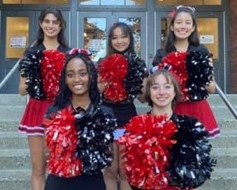 LHS cheerleaders in front of school building